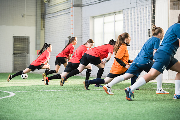 Female footballers at indoor football training